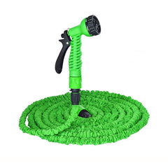 Green expandable garden hose with a black spray nozzle on a white background