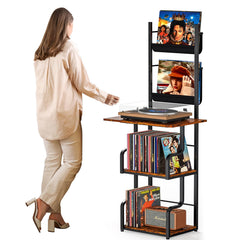 A woman in a beige outfit stands beside a black metal and wood record shelf unit holding DVDs, a turntable, and framed pictures. The shelf has three open shelves and side holders.