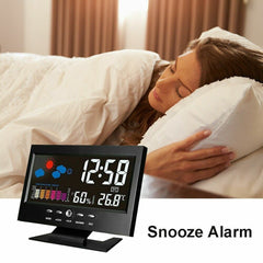 Woman sleeping in bed with a digital alarm clock displaying time and weather information.