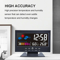 Digital clock with temperature and humidity display on a white surface.