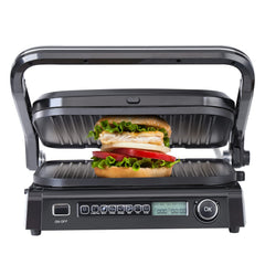 Panini press with a sandwich inside on a white background