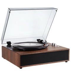 A wooden turntable with a clear glass dust cover open, showing a vinyl record on the platter and silver tonearm controls, photographed on a white background.
