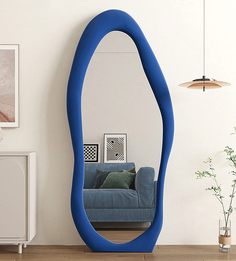 Blue floor mirror in a room with a couch and decor