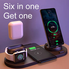 A six-in-one wireless charging stand shown with multiple devices: a smartphone on a vertical charging dock, another phone on a horizontal charging pad, an Apple Watch, and a white earbud case floating above. Large text reads 'Six in one Get one' against a purple-lavender background.