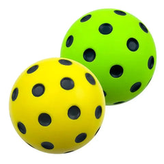 Two balls, one green and one yellow, with black spots on a white background