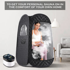 Portable sauna tent with a woman inside, placed in a room with a gray couch and white wall.