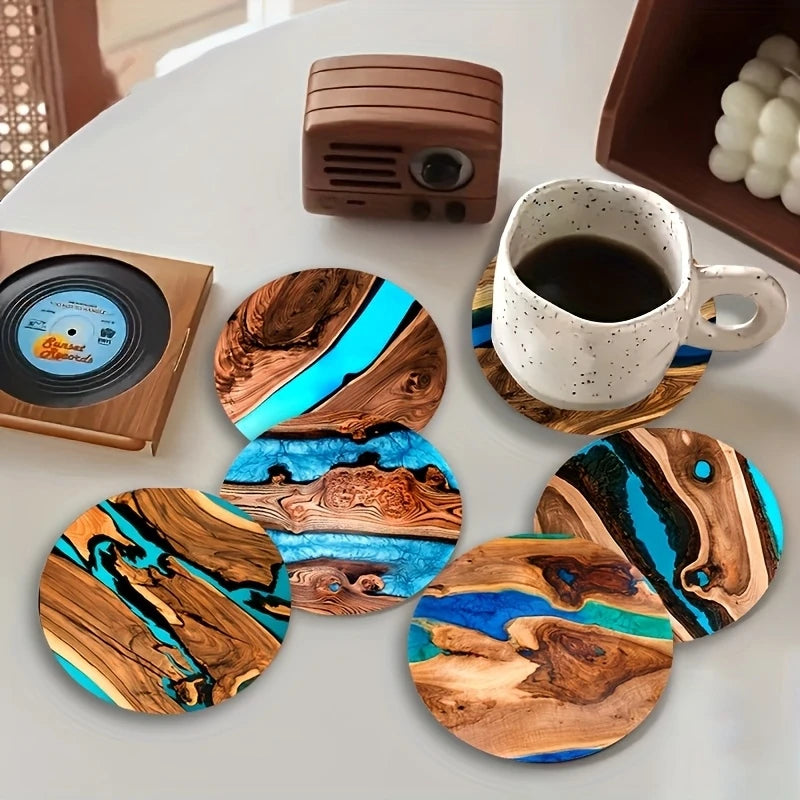 Wooden coasters with blue and brown design on a table with a cup of coffee.