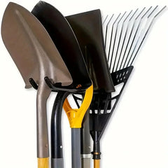 Set of gardening tools including a shovel, spade, and rake on a white background