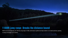 Person using a flashlight in a dark outdoor setting with text highlighting its long-range capability.