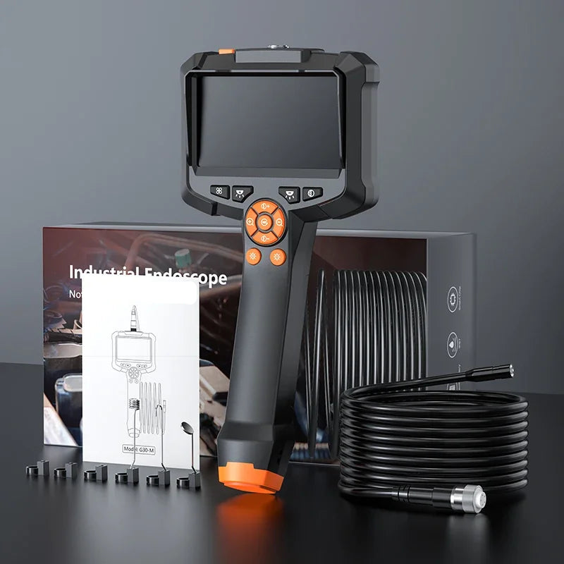 Industrial endoscope with coiled cable on a dark surface against a gray background