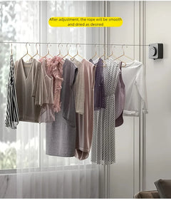 A set of women's casual dresses and tops in soft neutral and pastel tones hanging on a clothesline with wooden hangers in a bright, modern room. A yellow text bubble at the top reads 'After adjustment, the rope will be smooth and dried as desired'.