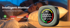 A smart sleep safety monitor shown prominently in the foreground, with a sleeping person in bed blurred in the background. The device has a dark gray body and a circular display showing CO2 and temperature readings, with marketing text on the left about visual and audible alarms.