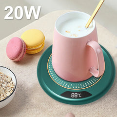 Pink mug on a green heating pad with macarons and oats on a beige surface