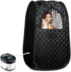 A black quilted portable hot spring or sauna tent with a clear plastic window showing a woman inside, alongside a small white and black heating base on a white background.