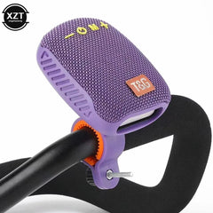 A purple JBL portable speaker mounted on a black bicycle handlebar with a purple and orange clamp, shown against a white background with a black XZT watermark in the top-left corner.