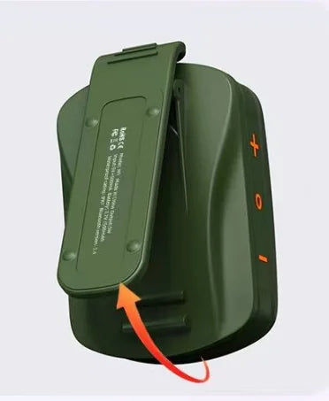 An olive green electronic device with a hinged lid shown open, featuring orange plus and minus symbols on the side and a red arrow pointing to the underside of the lid.
