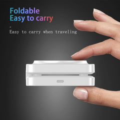 A white foldable portable device held between two hands against a dark gray gradient background, with promotional text reading 'Foldable Easy to carry' and 'Easy to carry when traveling'.
