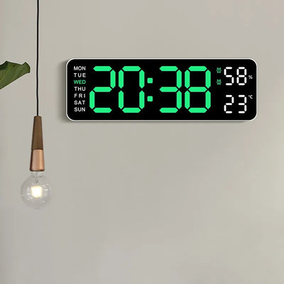 A rectangular digital wall clock with a black face and bright green LED numbers, mounted on a light gray wall. The clock shows the time 20:38, days of the week from MON to SUN, and temperature readings in Fahrenheit and Celsius.