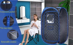 A portable pop-up sauna tent with a blue border and dark gray quilted interior, shown next to a woman in a white robe sitting in a folding chair inside a bathroom. The left side includes circular inset callouts highlighting features: a convenient pocket, two-way zipper, and removable window.
