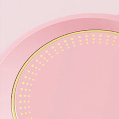 Pink plate with yellow polka dot pattern on a light pink background