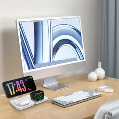 Modern office desk setup with computer monitor, keyboard, mouse, and smart devices on a wooden surface.