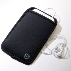 Black phone case with a heart logo on a beige surface, accompanied by white earphones.