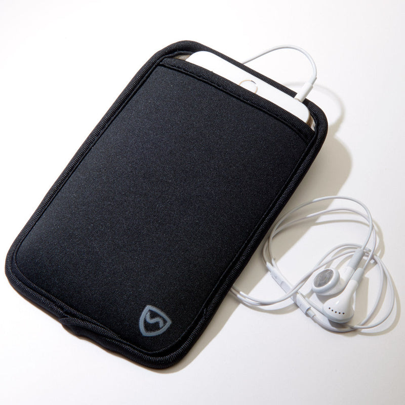 Black phone case with a heart logo on a beige surface, accompanied by white earphones.