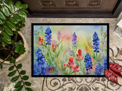 Decorative doormat with floral design on a tiled floor.