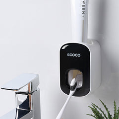 Wall-mounted toothbrush holder with a toothbrush attached, branded 'ecoco'.