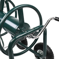 Close-up of a green wheelbarrow with wheels and handle on a white background
