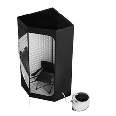 Black soundproofing booth with a chair inside, next to a white mug on a white background