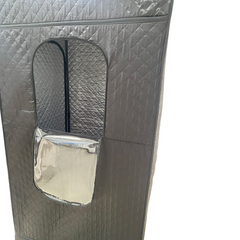 Gray quilted bag with a silver patch on a white background