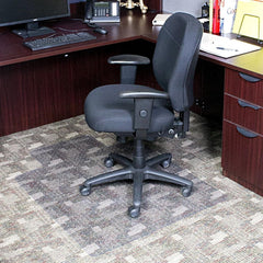 Gray office chair in front of a wooden desk with office supplies.