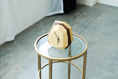 Geometric clock on a glass table with a minimal background