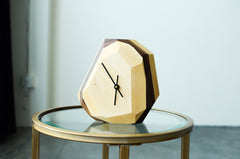 Geometric clock on a glass table with a minimal background