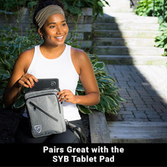Woman holding a SYB tablet pad in an outdoor setting